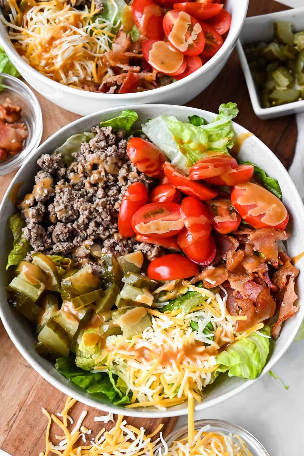 close up shot of big mac bowl with sauce drizzled over burger toppings.