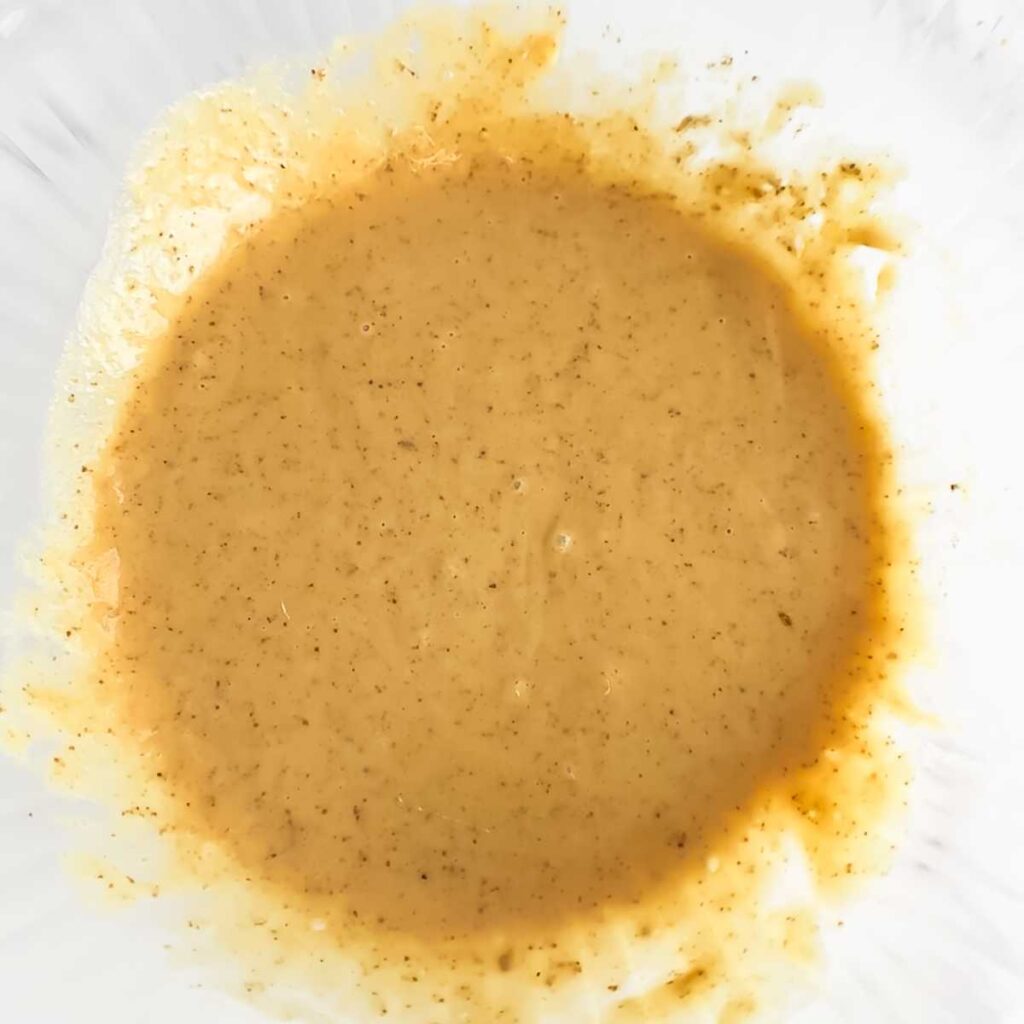 wet muffin batter in a large glass bowl.